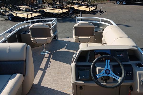 Slide: The Image of 2024 Sun Tracker Fishin' Barge 20 DLX interior with steering wheel and seating. - 9