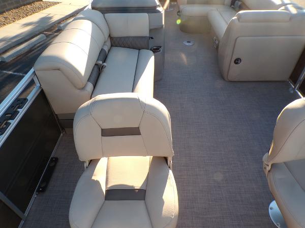 Slide: The Image of 2024 Sun Tracker FISHIN' BARGE® 22 DLX interior with beige seating and spacious layout. - 11