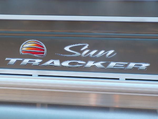 Slide: The Image of 2024 Sun Tracker FISHIN' BARGE® 22 DLX logo on boat exterior. - 4