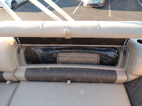 Slide: The Image of 2024 Sun Tracker FISHIN' BARGE® 22 DLX storage compartment with cushioned seating. - 5