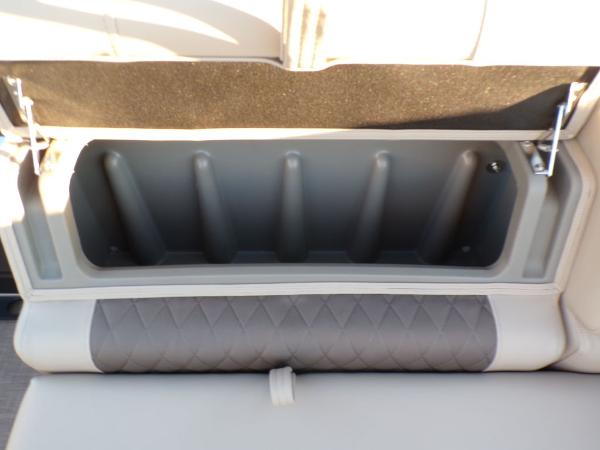 Slide: The Image of 2024 Sun Tracker FISHIN' BARGE® 22 DLX storage compartment with cushioned seating. - 8