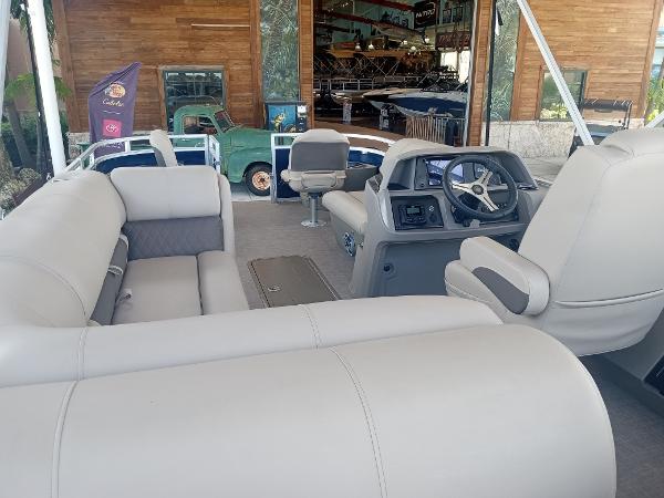 Slide: The Image of 2024 Sun Tracker Fishin' Barge 22 XP3 interior with plush seating and modern helm. - 12
