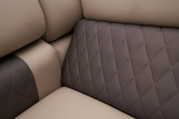 Slide: The Image of 2024 Sun Tracker Fishin' Barge 22 XP3, close-up of beige and brown quilted upholstery. - 33