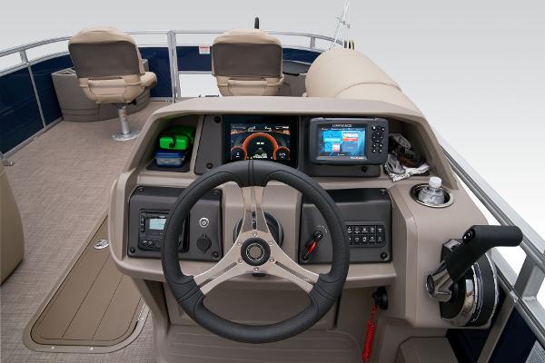 Slide: The Image of 2024 Sun Tracker Fishin' Barge 22 XP3 boat dashboard with steering wheel and navigation system. - 42