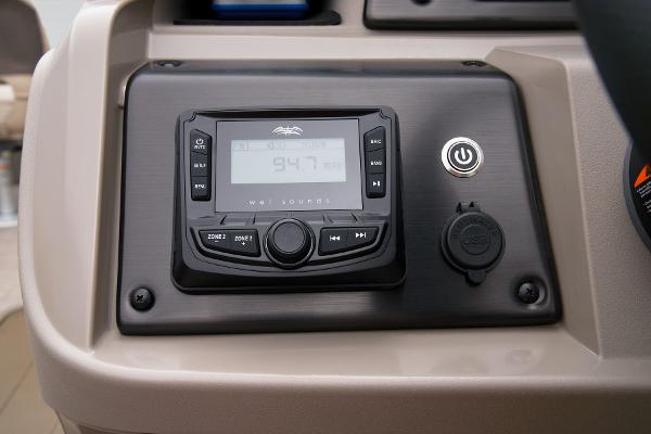Slide: The Image of 2024 Sun Tracker Fishin' Barge 22 XP3 dashboard with radio and power button. - 47