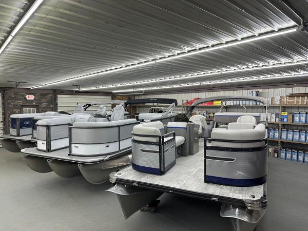 Slide: The Image of 2018 Sun Tracker Party Barge 18 DLX pontoon boats in indoor showroom. - 11