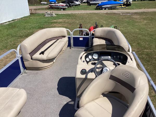 Slide: The Image of 2018 Sun Tracker Party Barge 18 DLX pontoon boat interior with beige seating and steering console. - 4
