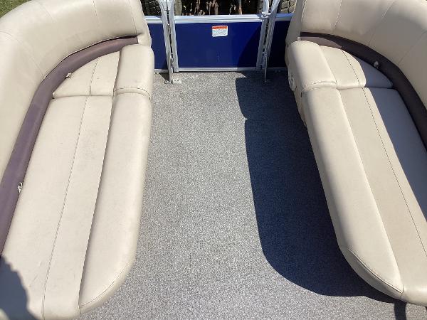 Slide: The Image of 2018 Sun Tracker Party Barge 18 DLX interior seating area with beige cushions. - 7