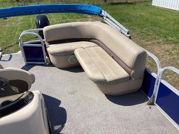 Slide: The Image of 2018 Sun Tracker Party Barge 18 DLX pontoon boat with beige seating and blue accents. - 9
