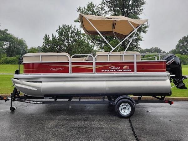 Slide: The Image of 2024 Sun Tracker Party Barge 18 DLX pontoon boat on trailer. - 0