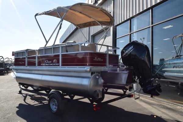 Slide: The Image of 2024 Sun Tracker Party Barge 18 DLX pontoon boat with canopy and outboard motor. - 2