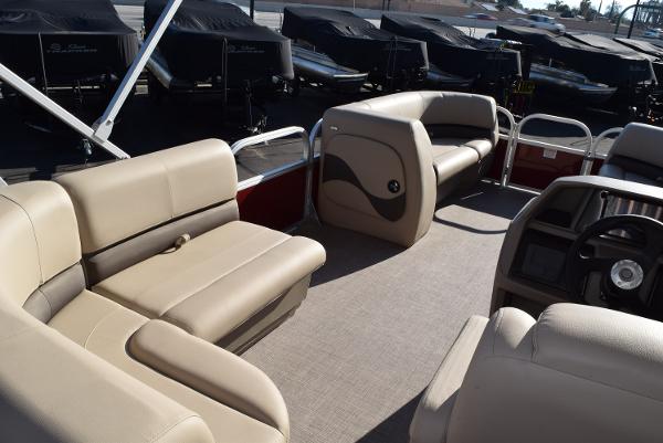 Slide: The Image of 2024 Sun Tracker Party Barge 18 DLX interior with beige seating and spacious layout. - 4