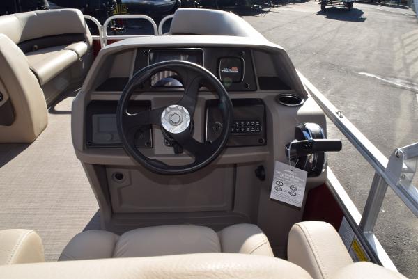 Slide: The Image of 2024 Sun Tracker Party Barge 18 DLX helm with steering wheel and controls. - 5