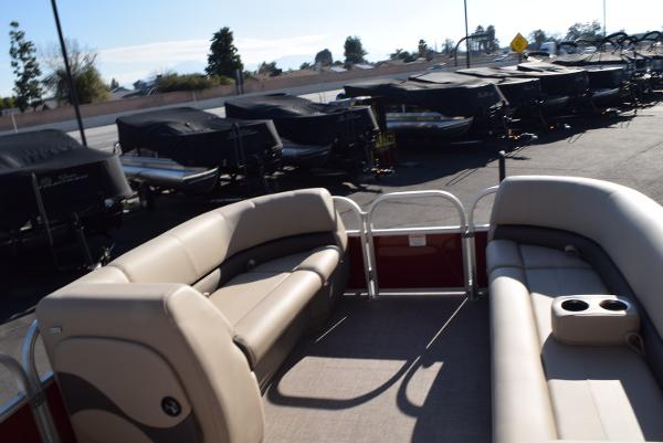Slide: The Image of 2024 Sun Tracker Party Barge 18 DLX pontoon boat interior with beige seating. - 6