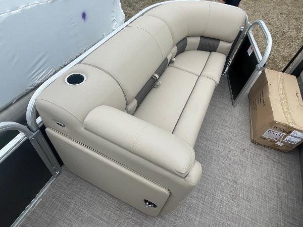 Slide: The Image of 2023 Sun Tracker Party Barge 20 DLX beige seating with cup holder, on deck. - 9