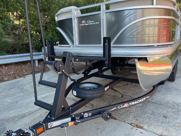 Slide: The Image of 2024 Sun Tracker Party Barge 20 DLX on trailer, front view. - 1