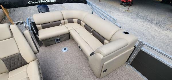 Slide: The Image of 2024 Sun Tracker PARTY BARGE® 20 DLX interior with beige seating and ample space. - 1