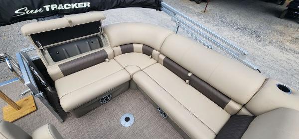 Slide: The Image of 2024 Sun Tracker PARTY BARGE® 20 DLX interior seating area with beige and brown upholstery. - 14