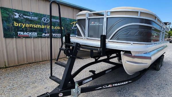 Slide: The Image of 2024 Sun Tracker PARTY BARGE® 20 DLX pontoon boat on trailer at dealership. - 16