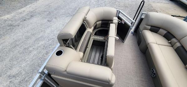 Slide: The Image of 2024 Sun Tracker PARTY BARGE® 20 DLX interior with beige seating and storage compartments. - 21