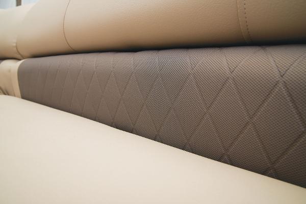 Slide: The Image of Close-up of 2024 Sun Tracker Party Barge 20 DLX beige and brown upholstery. - 29