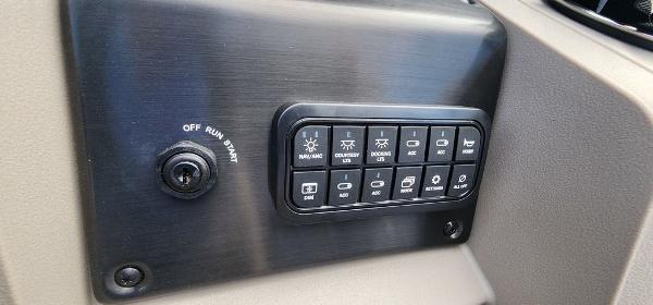 Slide: The Image of Control panel of 2024 Sun Tracker PARTY BARGE® 20 DLX with various switches and ignition. - 3