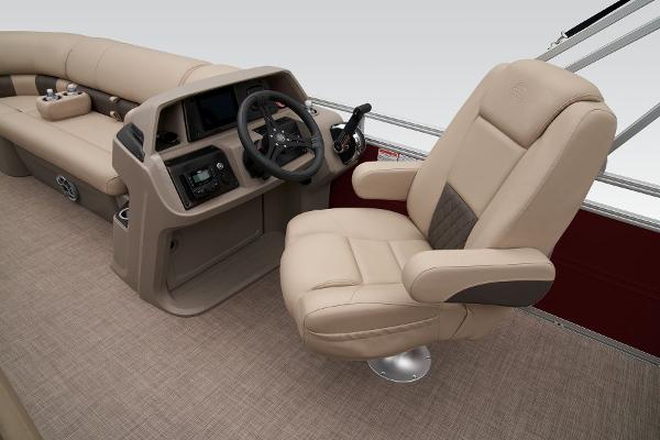 Slide: The Image of 2024 Sun Tracker Party Barge 20 DLX interior with captain's chair and steering console. - 30