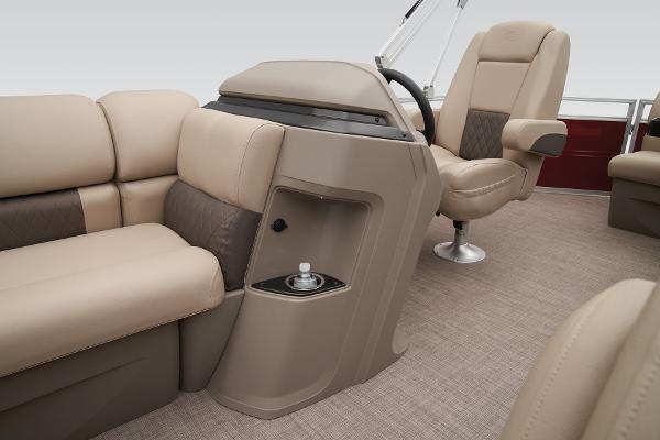 Slide: The Image of 2024 Sun Tracker Party Barge 20 DLX interior with beige seating and steering console. - 31