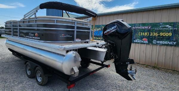Slide: The Image of 2024 Sun Tracker PARTY BARGE® 20 DLX pontoon boat on a trailer with Mercury outboard motor. - 5