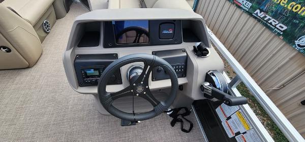 Slide: The Image of 2024 Sun Tracker PARTY BARGE® 20 DLX steering console with controls and display. - 6