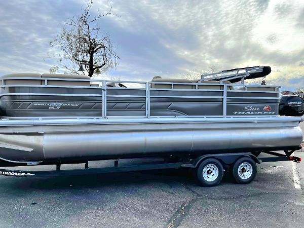Slide: The Image of 2024 Sun Tracker Party Barge 22 RF DLX pontoon boat on trailer. - 1