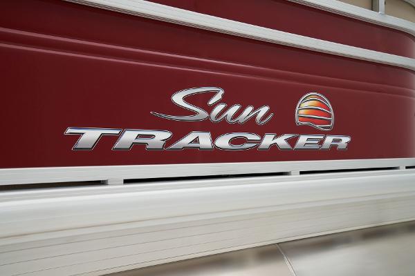 Slide: The Image of 2024 Sun Tracker Party Barge 22 XP3 logo on red boat exterior. - 13