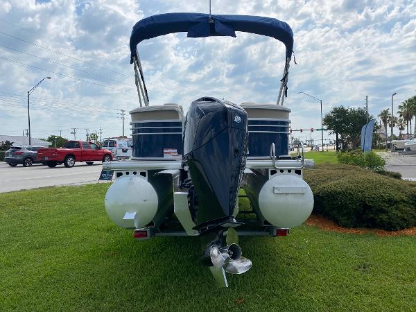 Slide: The Image of 2021 Sun Tracker Party Barge 24 DLX pontoon boat with outboard motor on grass. - 4