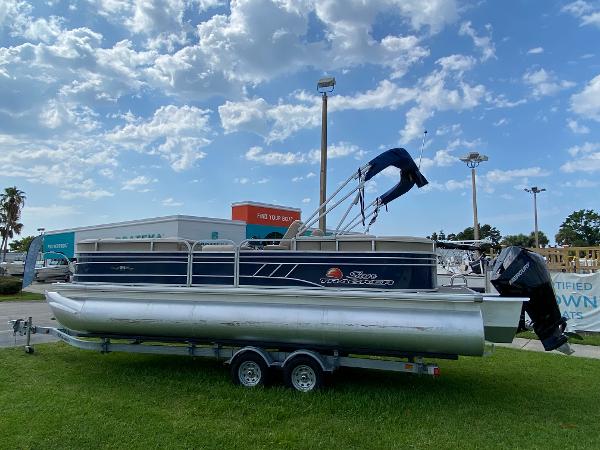Slide: The Image of 2021 Sun Tracker Party Barge 24 DLX pontoon boat on trailer, parked on grass. - 5