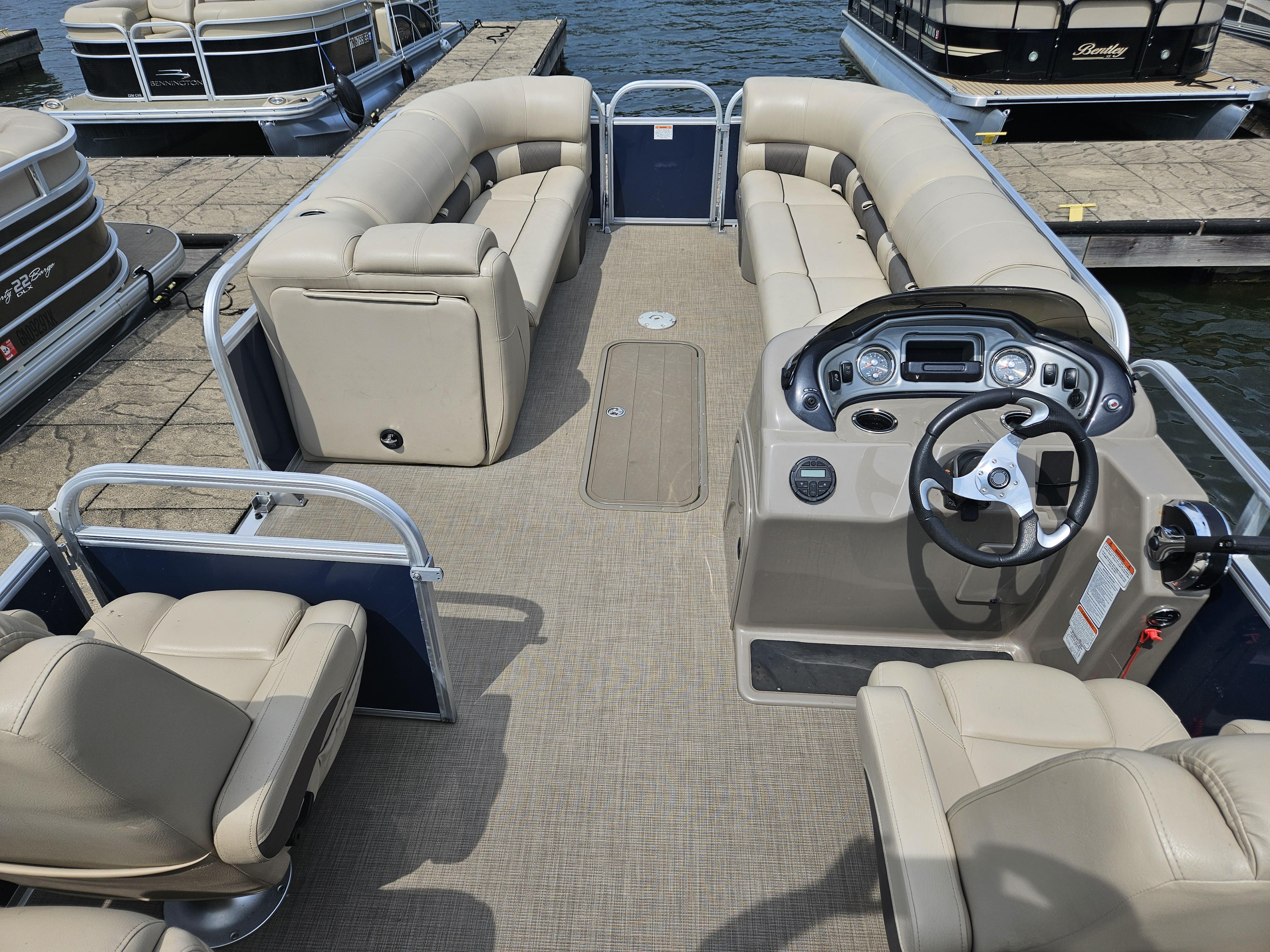 Slide: The Image of 2021 Sun Tracker Party Barge 24 XP3 pontoon boat interior with beige seating and control console. - 8