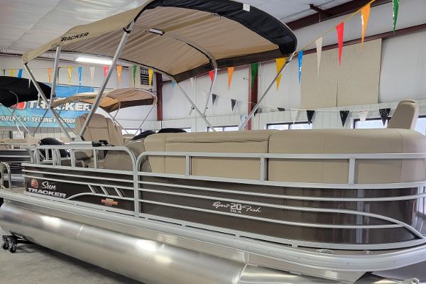 Slide: The Image of 2023 Sun Tracker SportFish 20 DLX pontoon boat in showroom. - 1