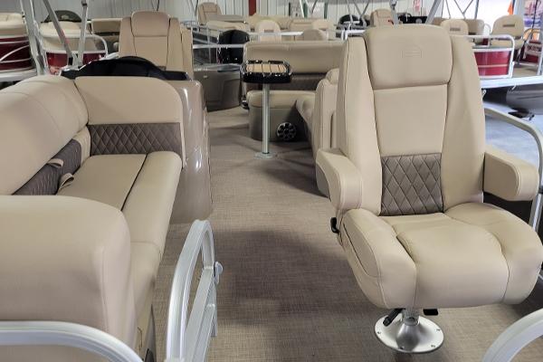 Slide: The Image of 2023 Sun Tracker SportFish 20 DLX interior with beige seating and modern design. - 2