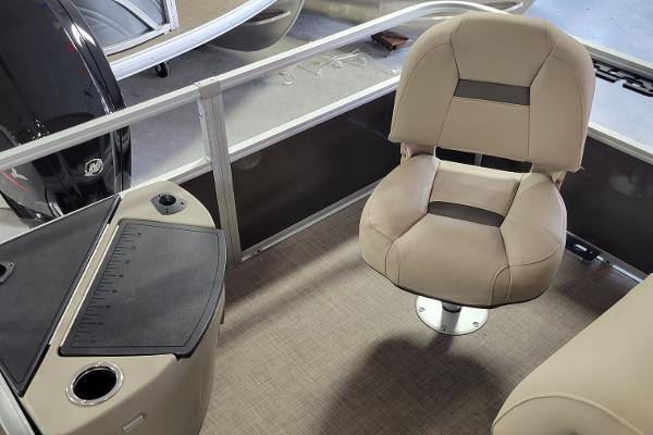 Slide: The Image of 2023 Sun Tracker SportFish 20 DLX boat interior with beige seating and fishing station. - 3