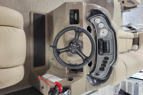 Slide: The Image of 2023 Sun Tracker SportFish 20 DLX boat dashboard with steering wheel and control panel. - 4