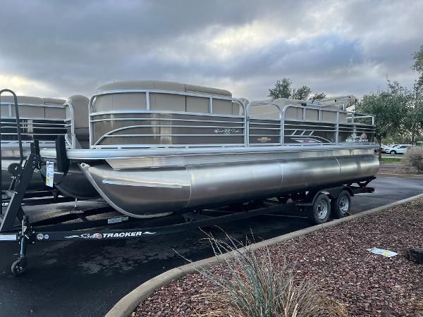 Slide: The Image of 2023 Sun Tracker SportFish 22 XP3 pontoon boat on a trailer. - 0