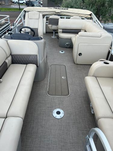 Slide: The Image of 2023 Sun Tracker SportFish 22 XP3 pontoon boat interior with beige seating. - 4
