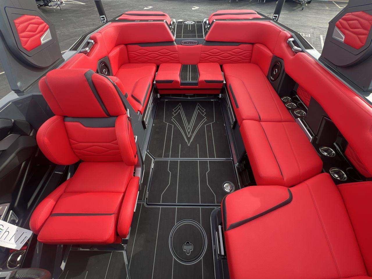 Slide: The Image of 2025 Supra SA boat interior with luxurious red seating and sleek black flooring. - 10