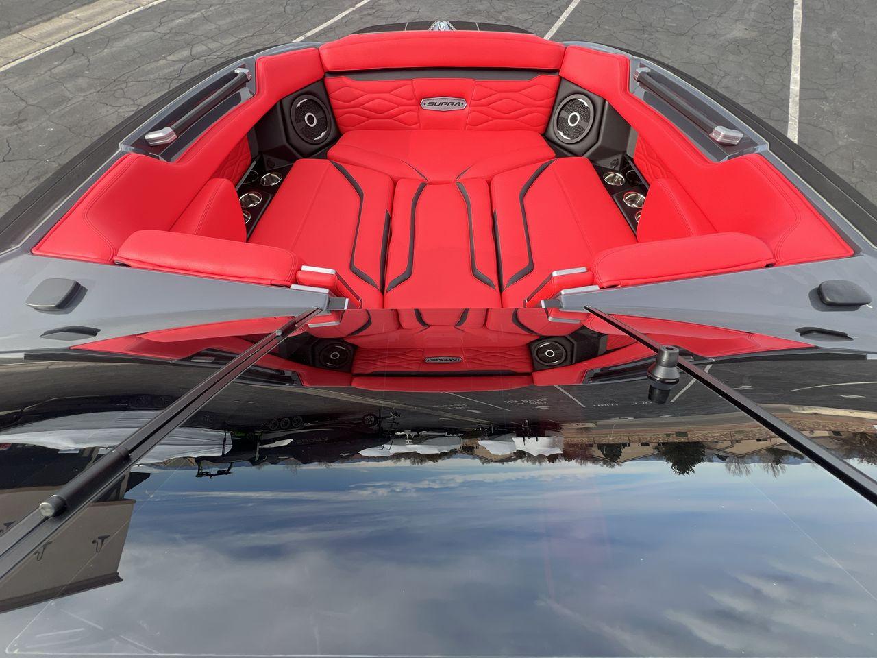 Slide: The Image of 2025 Supra SA boat with luxurious red seating and modern audio system. - 11