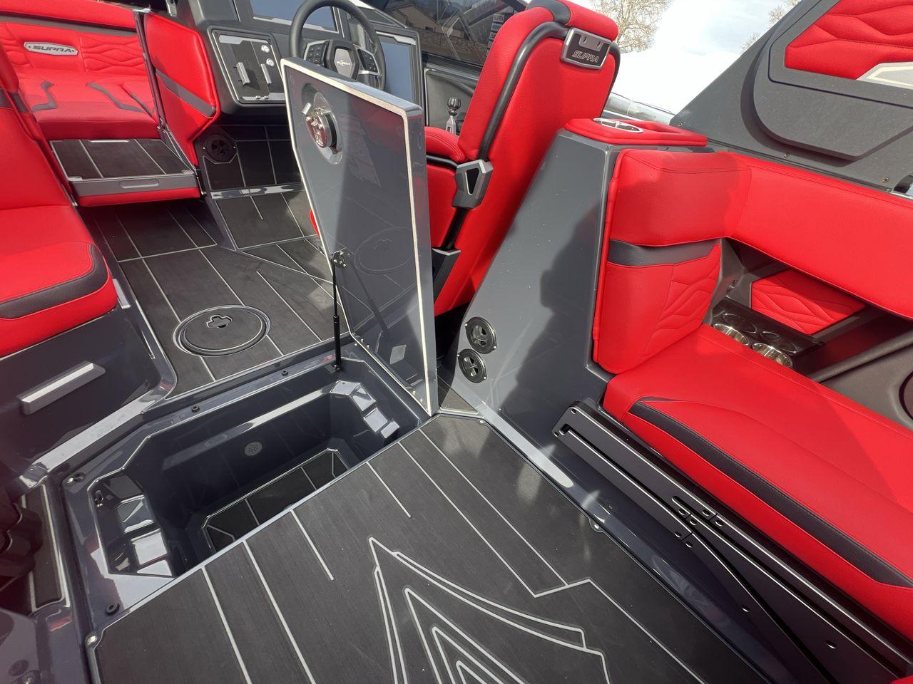 Slide: The Image of 2025 Supra SA boat interior with red seating and open storage compartment. - 22