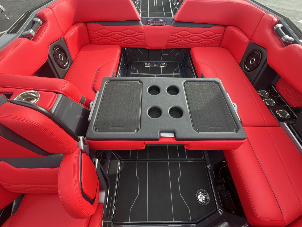 Slide: The Image of Luxurious 2025 Supra SA boat interior with red seating and integrated cup holders. - 23