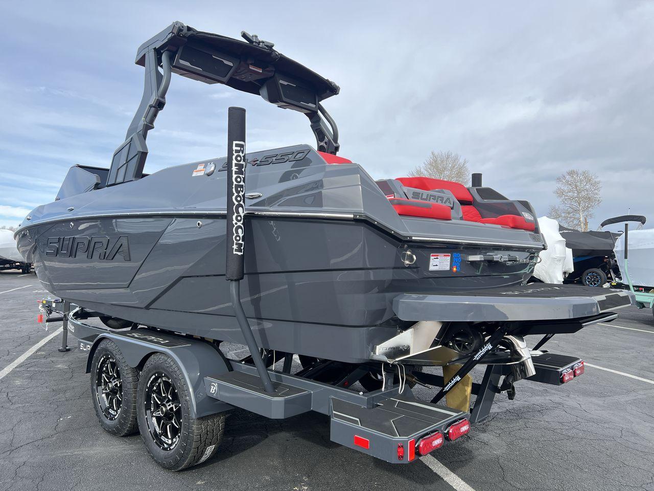 Slide: The Image of 2025 Supra SA boat with sleek gray design and red seating on a trailer. - 3