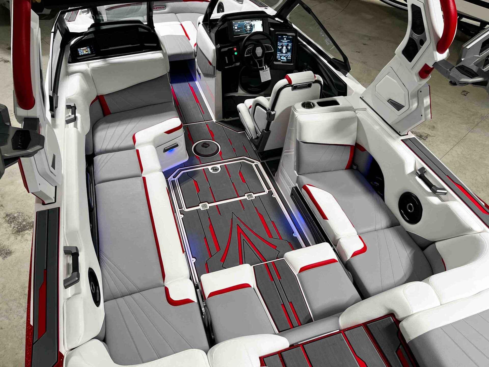 Slide: The Image of 2024 Supra SA400 boat interior with modern design, red and gray accents, and advanced dashboard. - 14