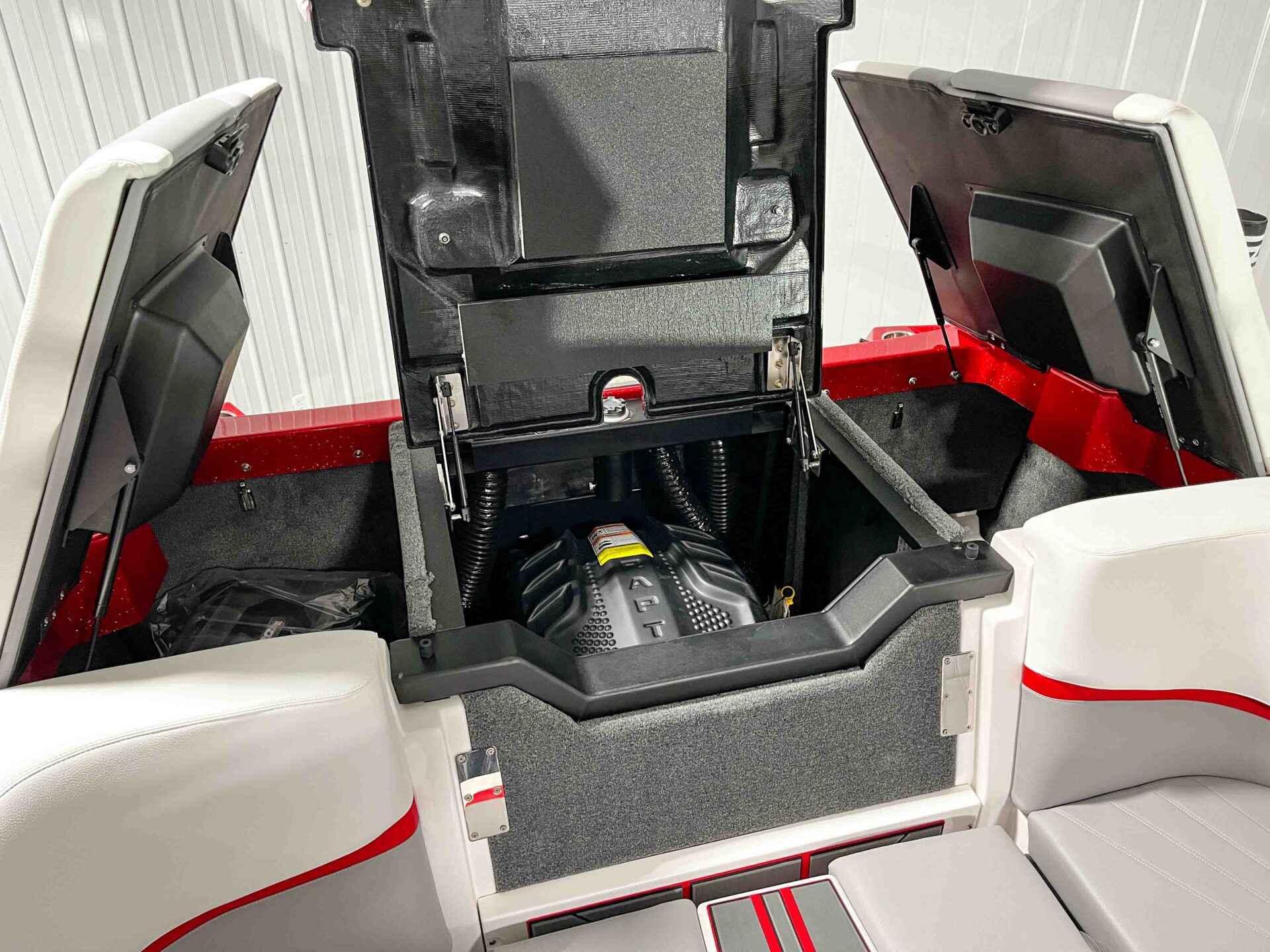 Slide: The Image of 2024 Supra SA400 boat engine compartment with open hatches, showcasing the engine and interior details. - 16