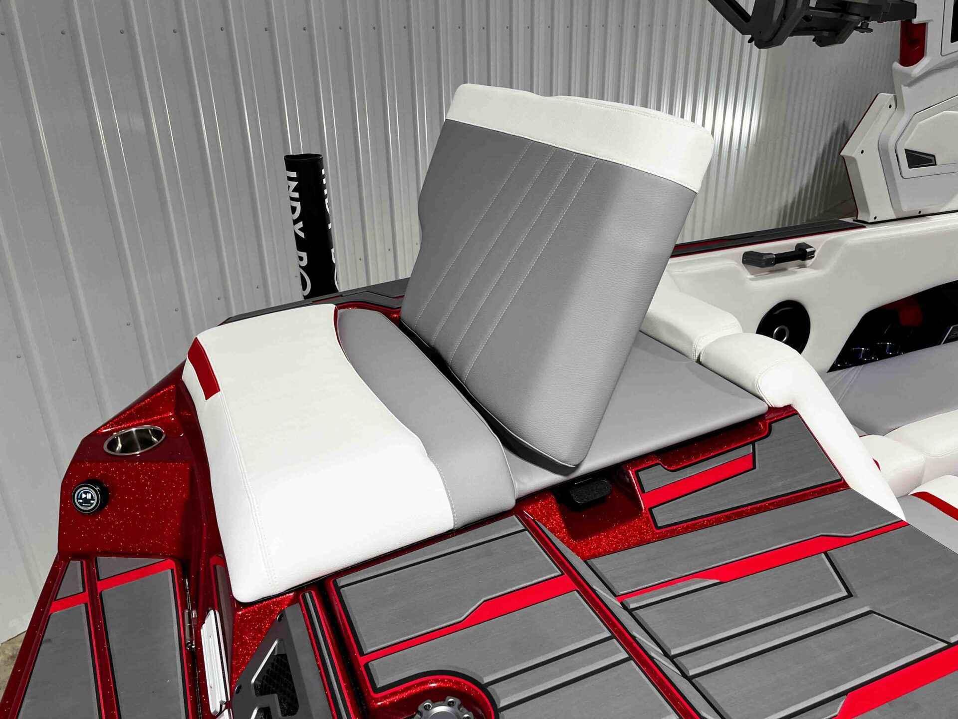 Slide: The Image of 2024 Supra SA400 boat interior with red and gray accents, adjustable seating, and cup holder. - 18