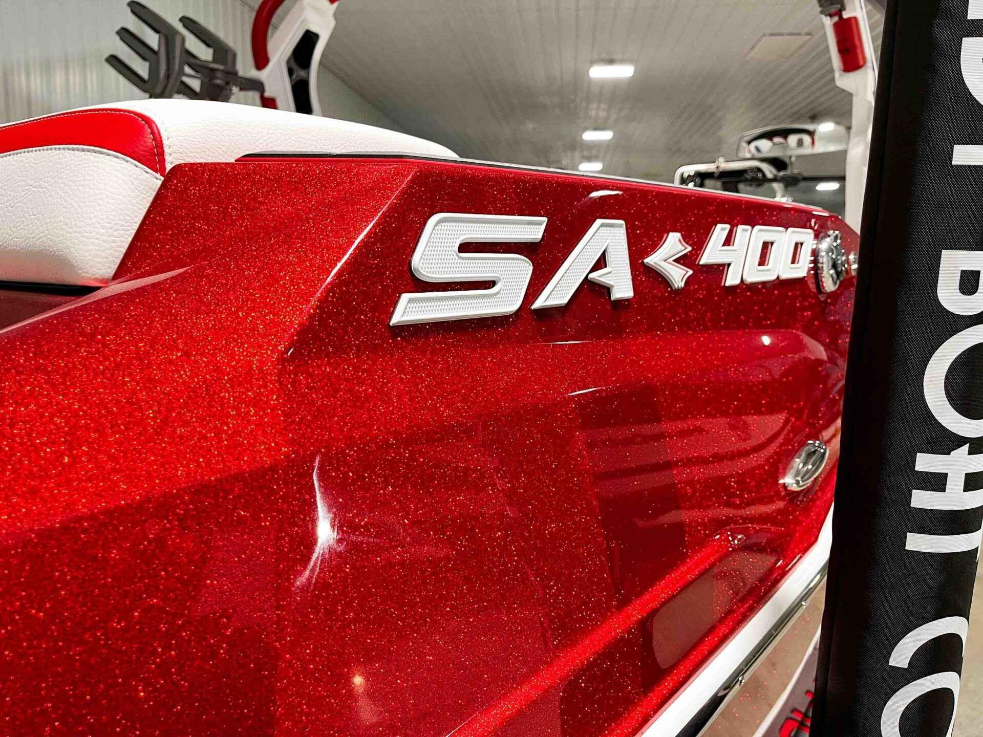 Slide: The Image of Close-up of 2024 Supra SA400 boat in sparkling red finish. - 6